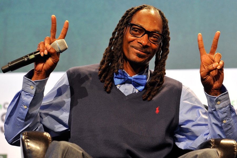 Snoop Dogg with Peace signs at a conference