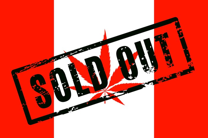 A Canadian flag with a cannabis leaf in place of the maple leaf, and the words sold out stamped across the flag.